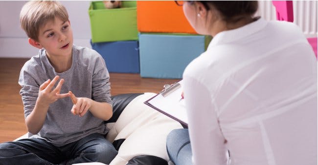A child receives therapy and counseling services from Burrell.